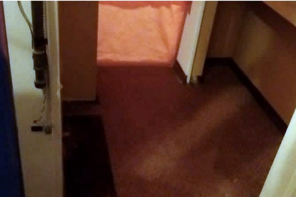 Corridor of a pre-1990 Calgary home with original carpet before asbestos testing