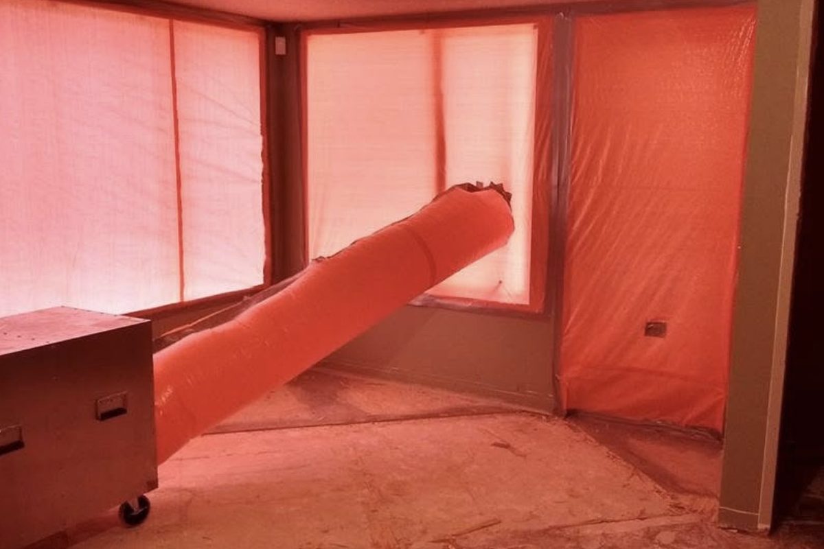 HEPA negative air machine running inside an asbestos containment
